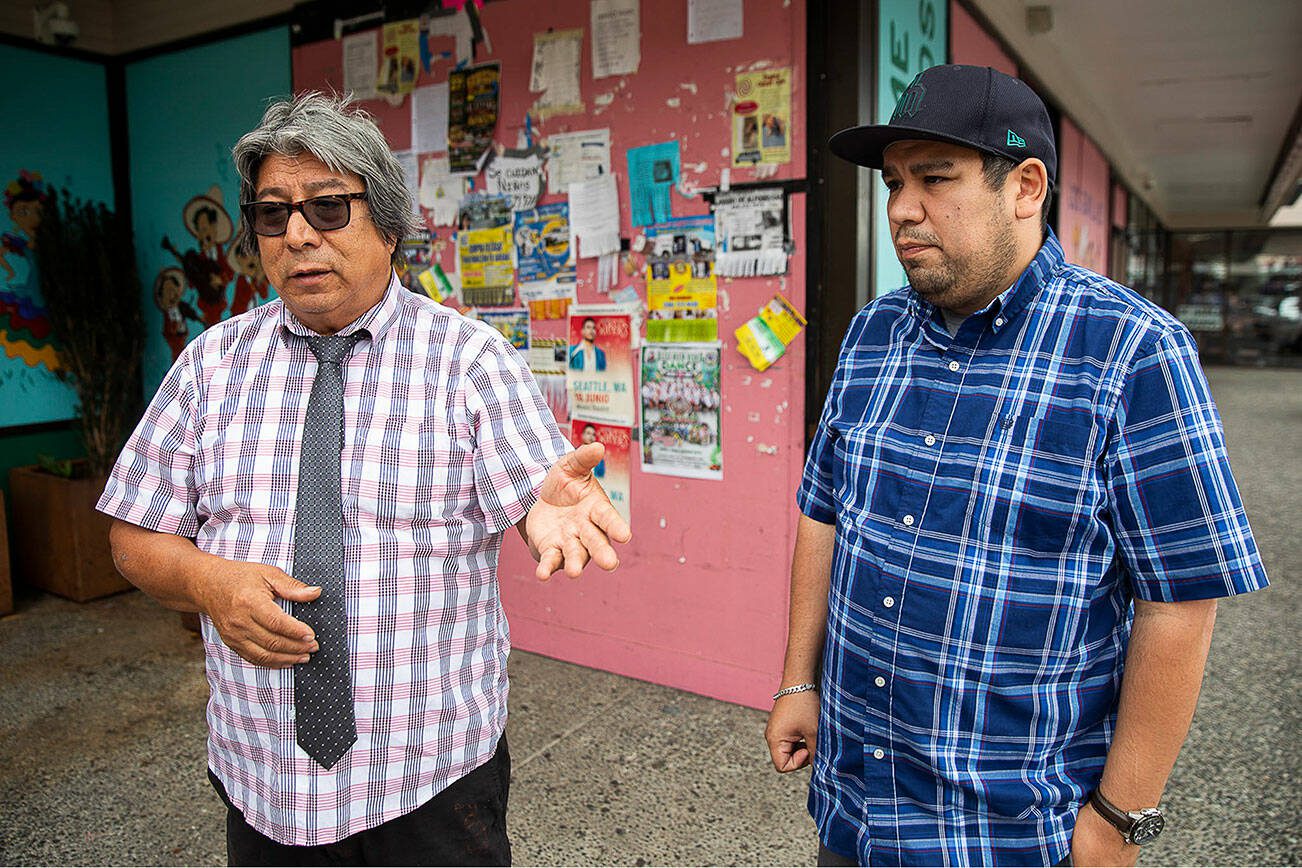 Felipe Hernandez, left, and his son Tony Hernandez speak about the impact the Light Rail plan would have on their business and the greater local community outside of their store on Tuesday, May 16, 2023 in Everett, Washington. (Olivia Vanni / The Herald)