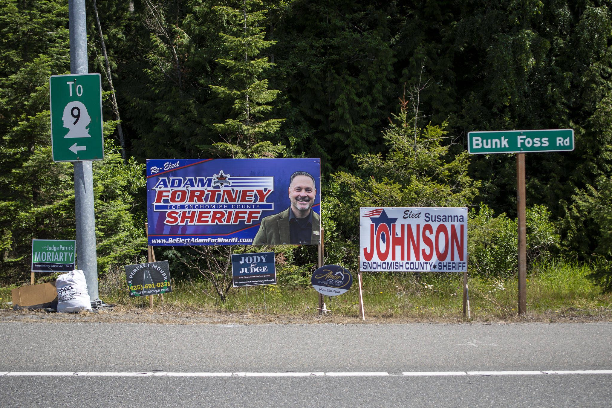 Political campaign signs posted for Adam Fortney, Susanna Johnson and others in Snohomish, Washington on Monday, July 3, 2023. (Annie Barker / The Herald)
