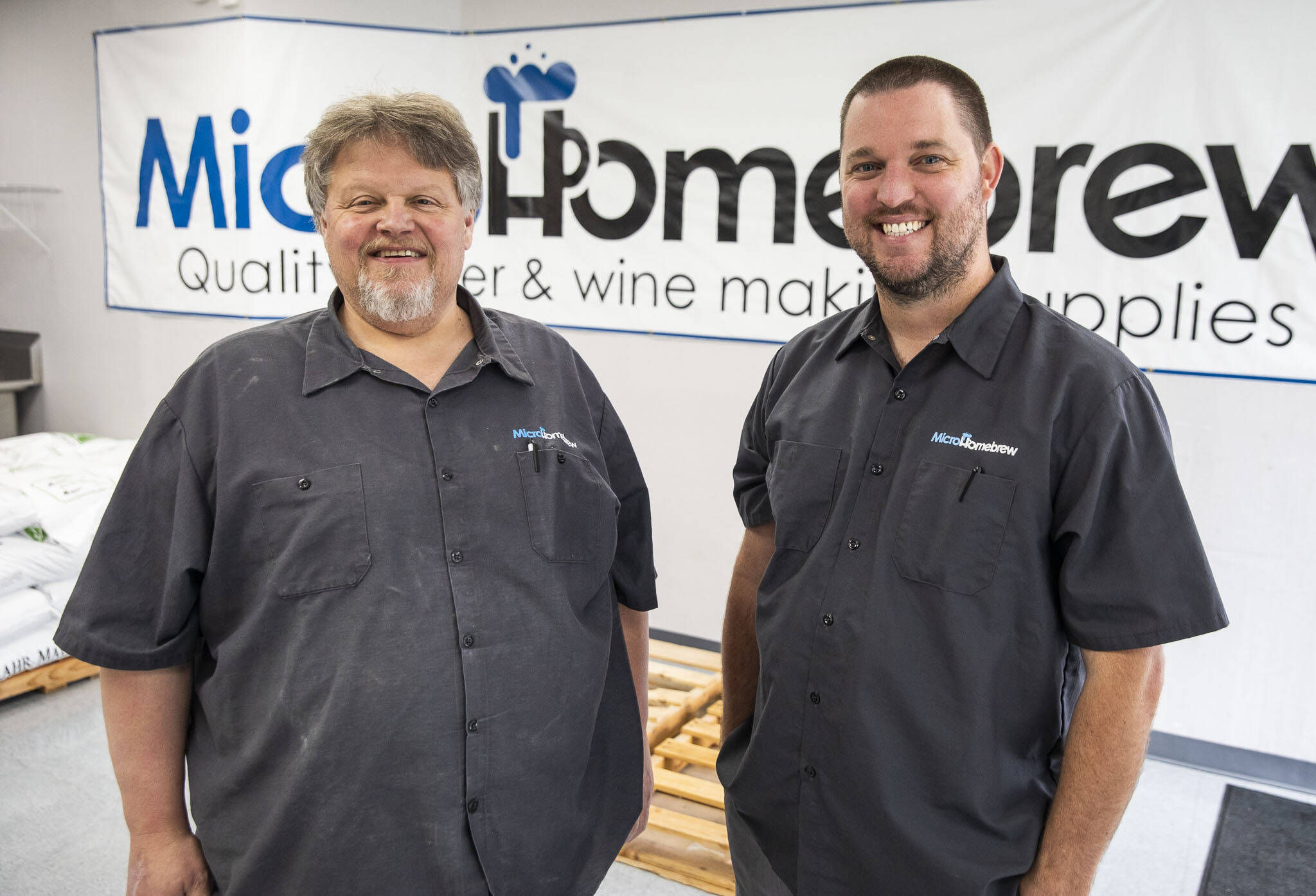 Original MicroHomebrew owner Tony Ochsner, left, and soon to be owner Corey DeJong, right, at their store on Monday, Aug. 7, 2023 in Kenmore, Washington. (Olivia Vanni / The Herald)