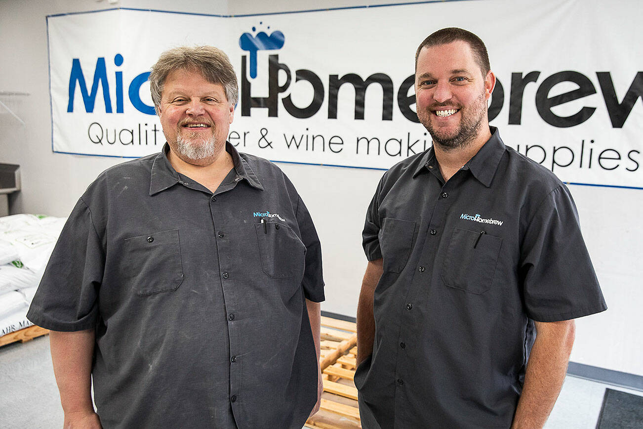 Original MicroHomebrew owner Tony Ochsner, left, and soon to be owner Corey DeJong, right, at their store on Monday, Aug. 7, 2023 in Kenmore, Washington. (Olivia Vanni / The Herald)