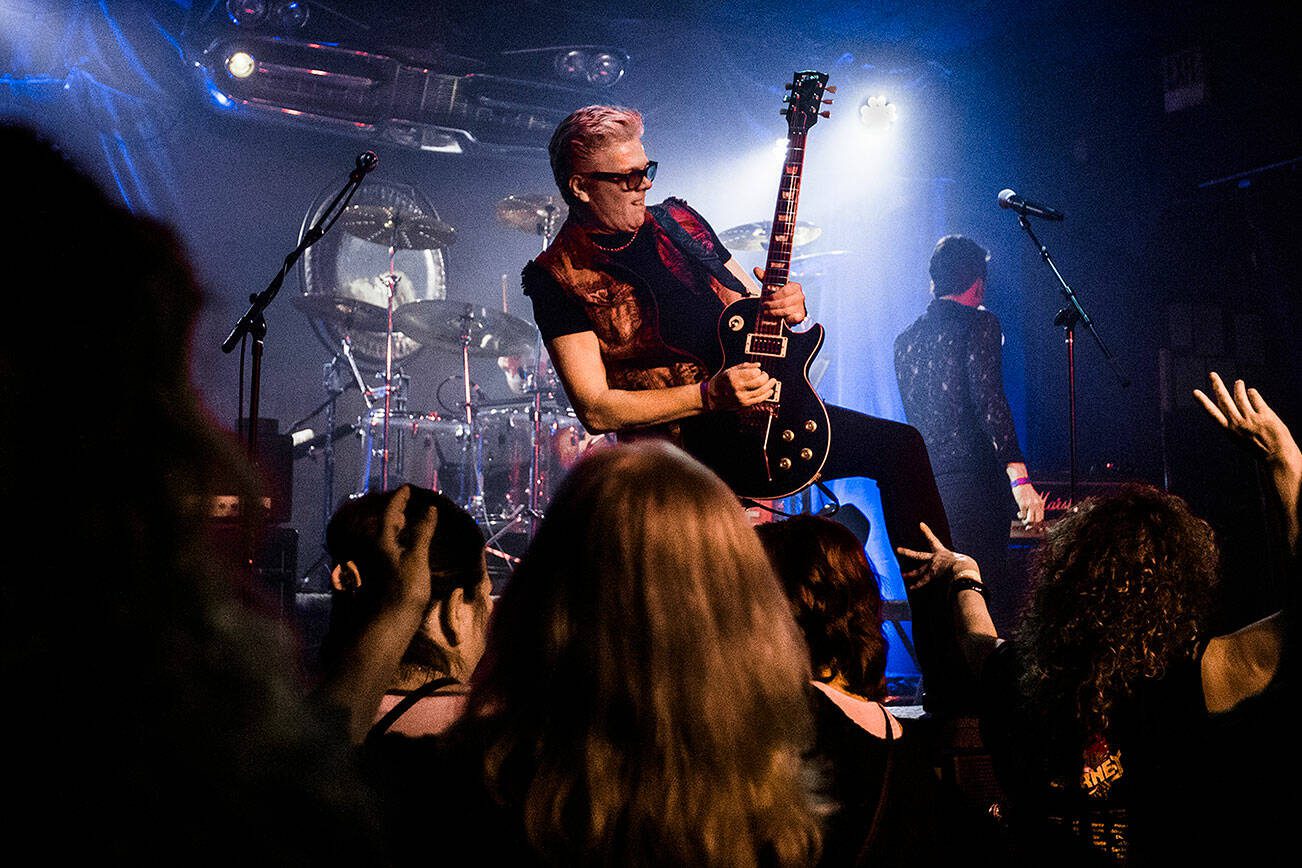 Dave Dodge stands on a speaker while playing his guitar during Nite Wave's show at Tony V's Garage on Saturday, June 8, 2019 in Everett, Wash. (Olivia Vanni / The Herald)