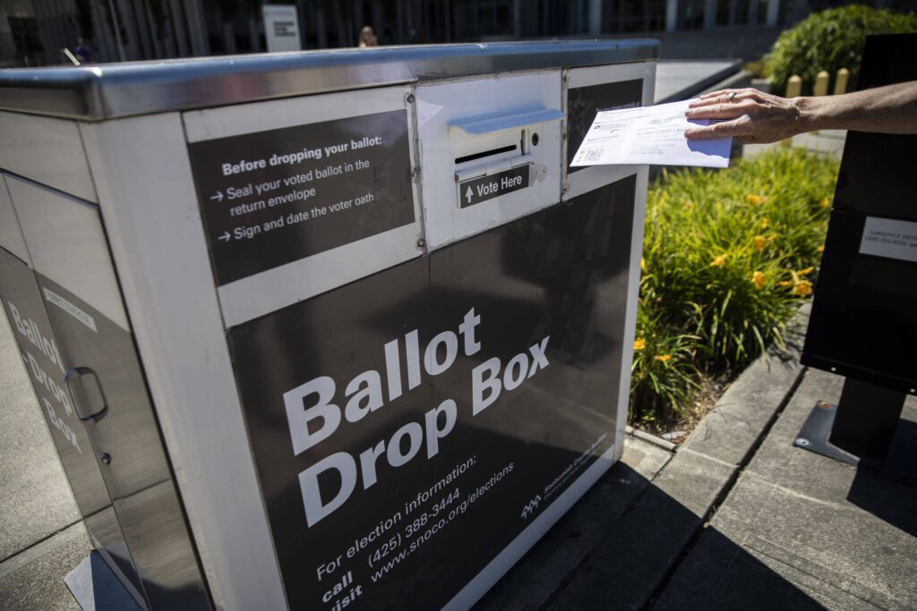 A person drops off their ballot on Tuesday, Aug. 1, 2023 in Everett, Washington. (Olivia Vanni / The Herald)
