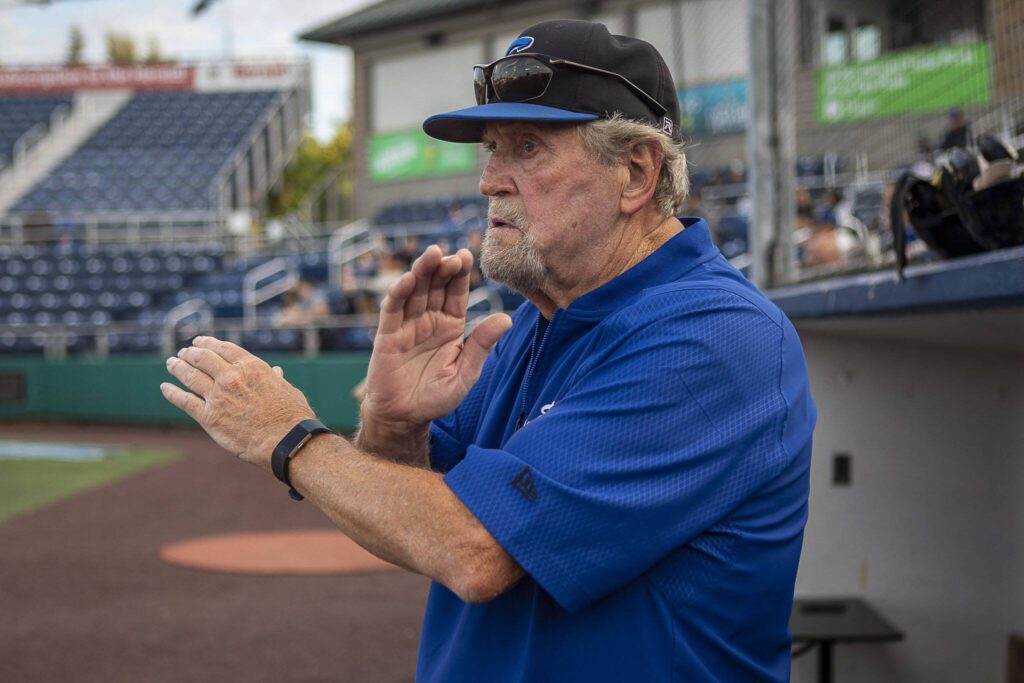 Everett Merchants manager Harold Pyatte gives a signal during a game on Friday at Funko Field in Everett. (Annie Barker / The Herald)

