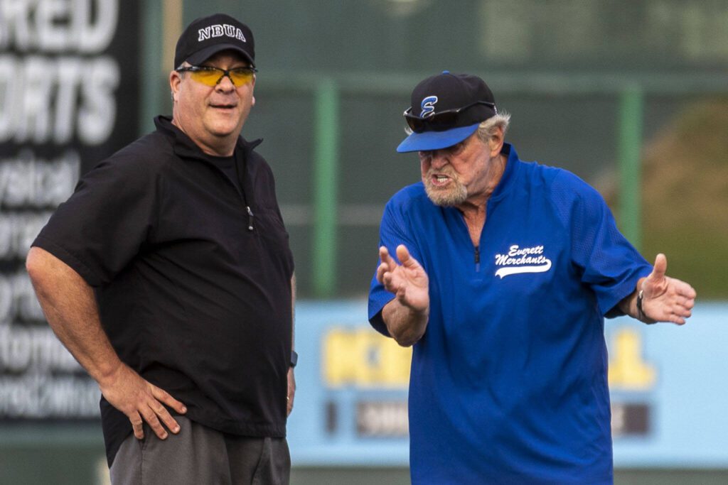 Everett Merchants manager Harold Pyatte (right) argues with an umpire during a game on Friday at Funko Field in Everett. (Annie Barker / The Herald)
