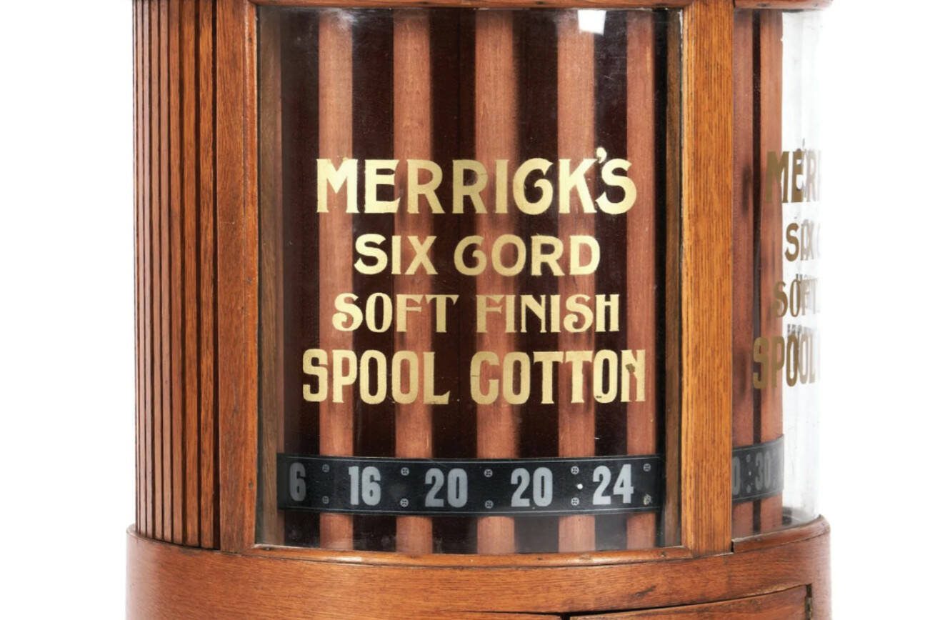 The Merrick Thread Company is known for its spool cabinets with rotating displays behind glass. They tend to sell for higher prices than the typical chest-of-drawers spool cabinet.