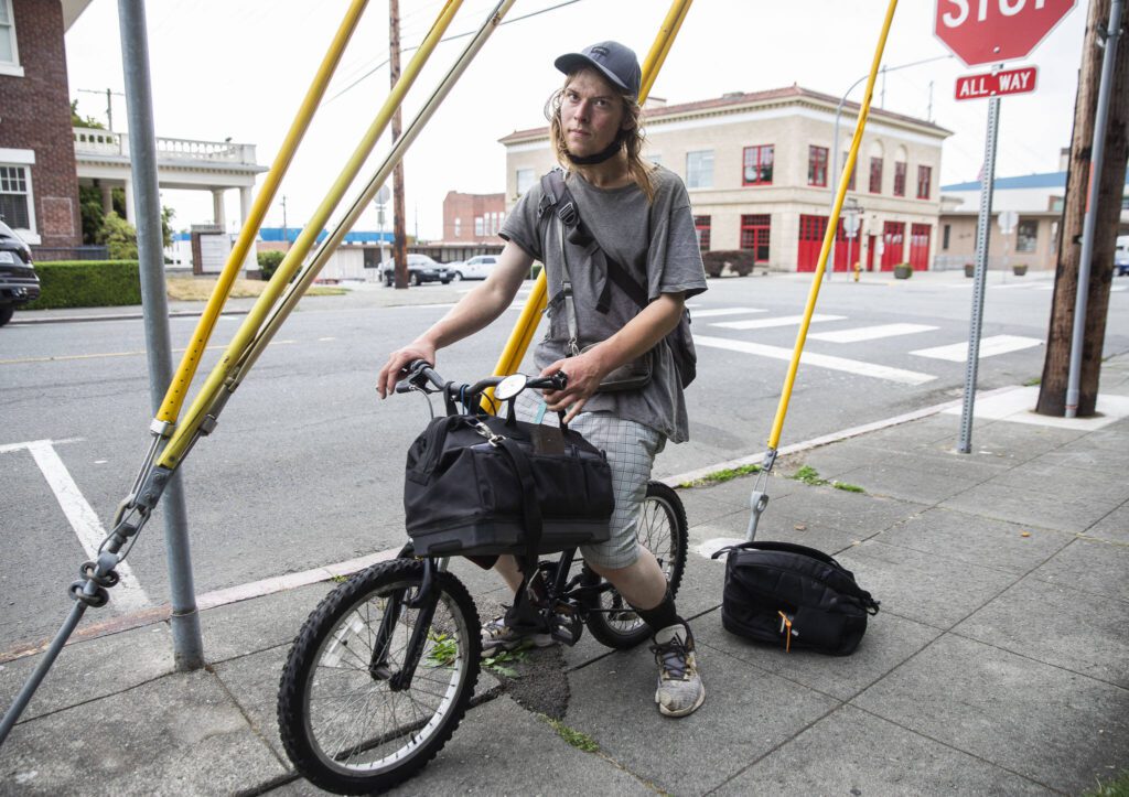 Dustin De Marcey rides his bike down Oakes Avenue on Tuesday, Aug. 8, 2023 in Everett, Washington. (Olivia Vanni / The Herald)
