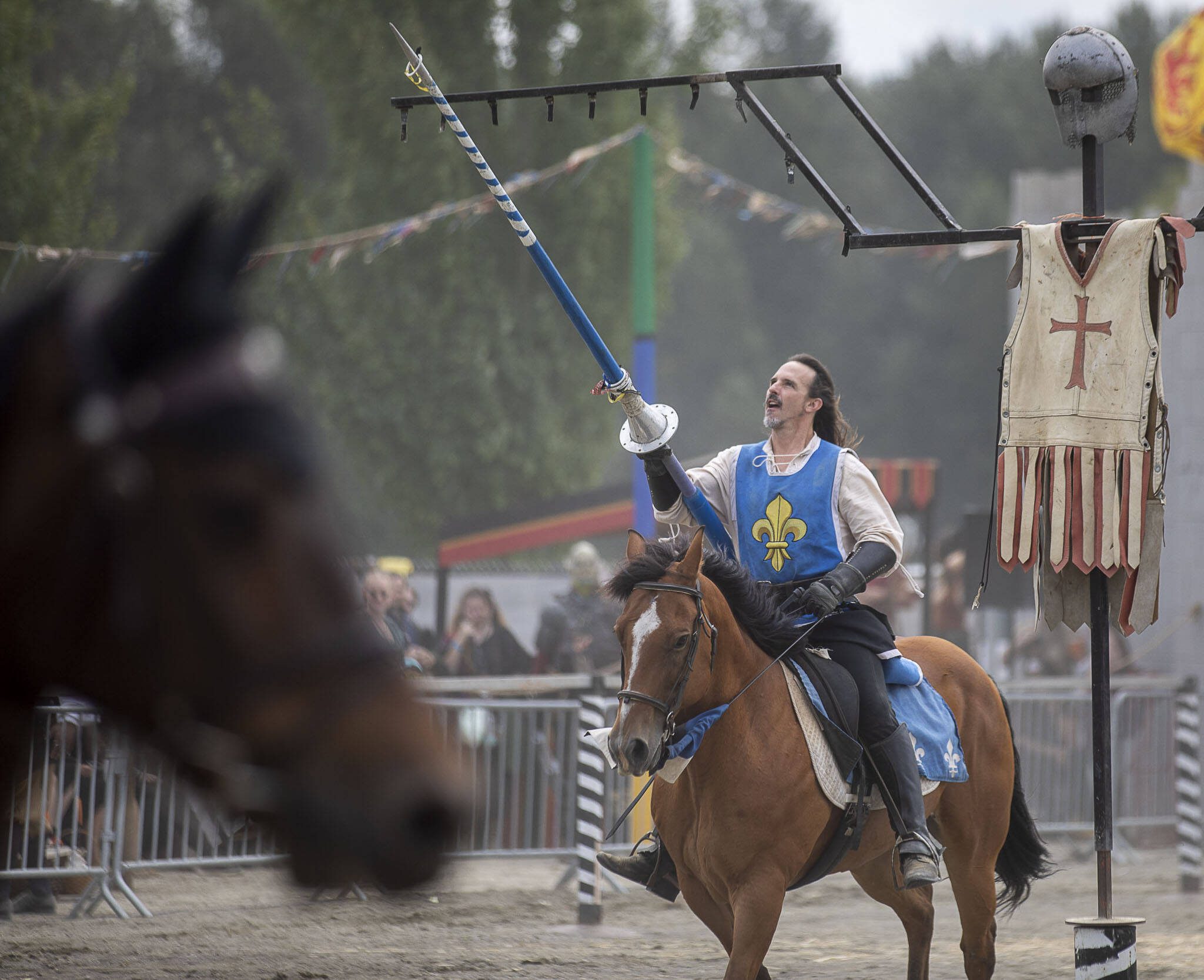 A performer uses his lance to target small rings during the Washington Midsummer Renaissance Faire at Sky Meadows Park in Snohomish, Washington, on Sunday, Aug. 6, 2023. (Annie Barker / The Herald)