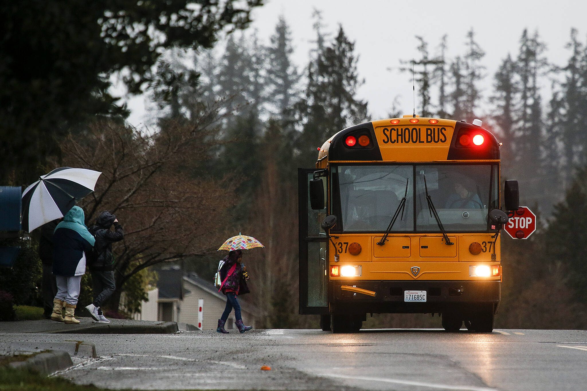 A school bus stops on 83rd Avenue Northeast in Marysville. (Ian Terry / The Herald)