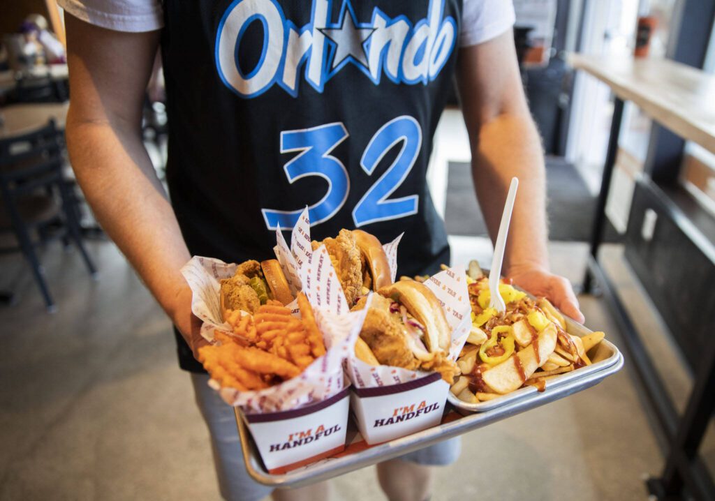 Tom Ceurvorst picks up his food order at Big Chicken on Thursday, Aug. 10, 2023 in Mukilteo, Washington. (Olivia Vanni / The Herald)
