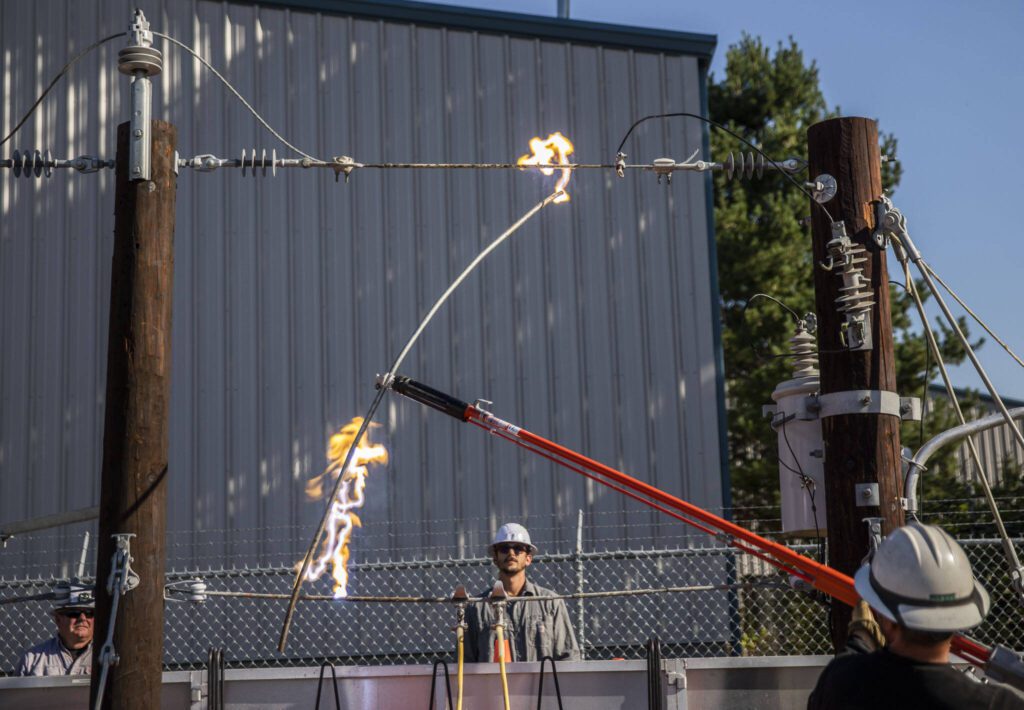 PUD lineman shows an electric arc during the high voltage trailer demonstration on Thursday, Aug. 17, 2023 in Arlington, Washington. (Olivia Vanni / The Herald)
