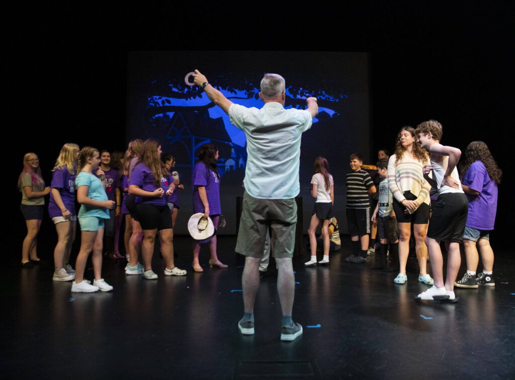 Bill Walles directs the actors during a dress rehearsal for Hope Theatre’s rendition of “Beauty and the Beast Jr.” on Friday, Aug. 4, 2023, at the Snohomish County PUD’s theater in Everett, Washington. (Olivia Vanni / The Herald)
