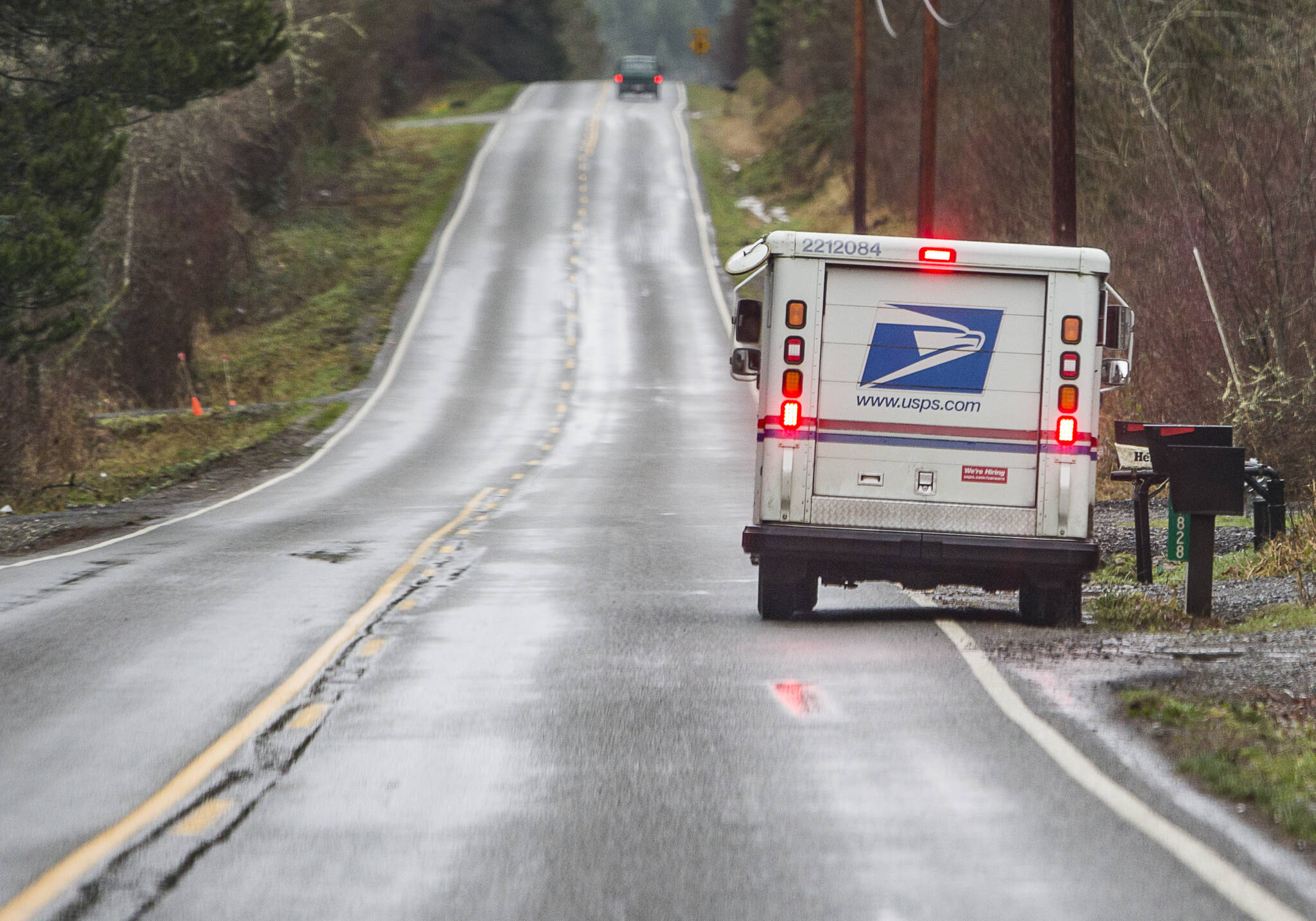 A mail carrier delivers mail along Dubuque Road in Snohomish on Wednesday, Jan. 12, 2022. (Olivia Vanni / The Herald)