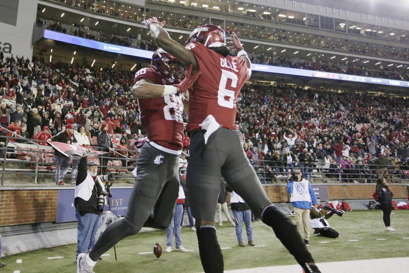 Washington State wide receiver De'Zhaun Stribling (88) celebrates his touchdown with teammate Donovan Ollie (6) during the first half of an NCAA college football game against Utah, Thursday, Oct. 27, 2022, in Pullman, Wash. (AP Photo/Young Kwak)
