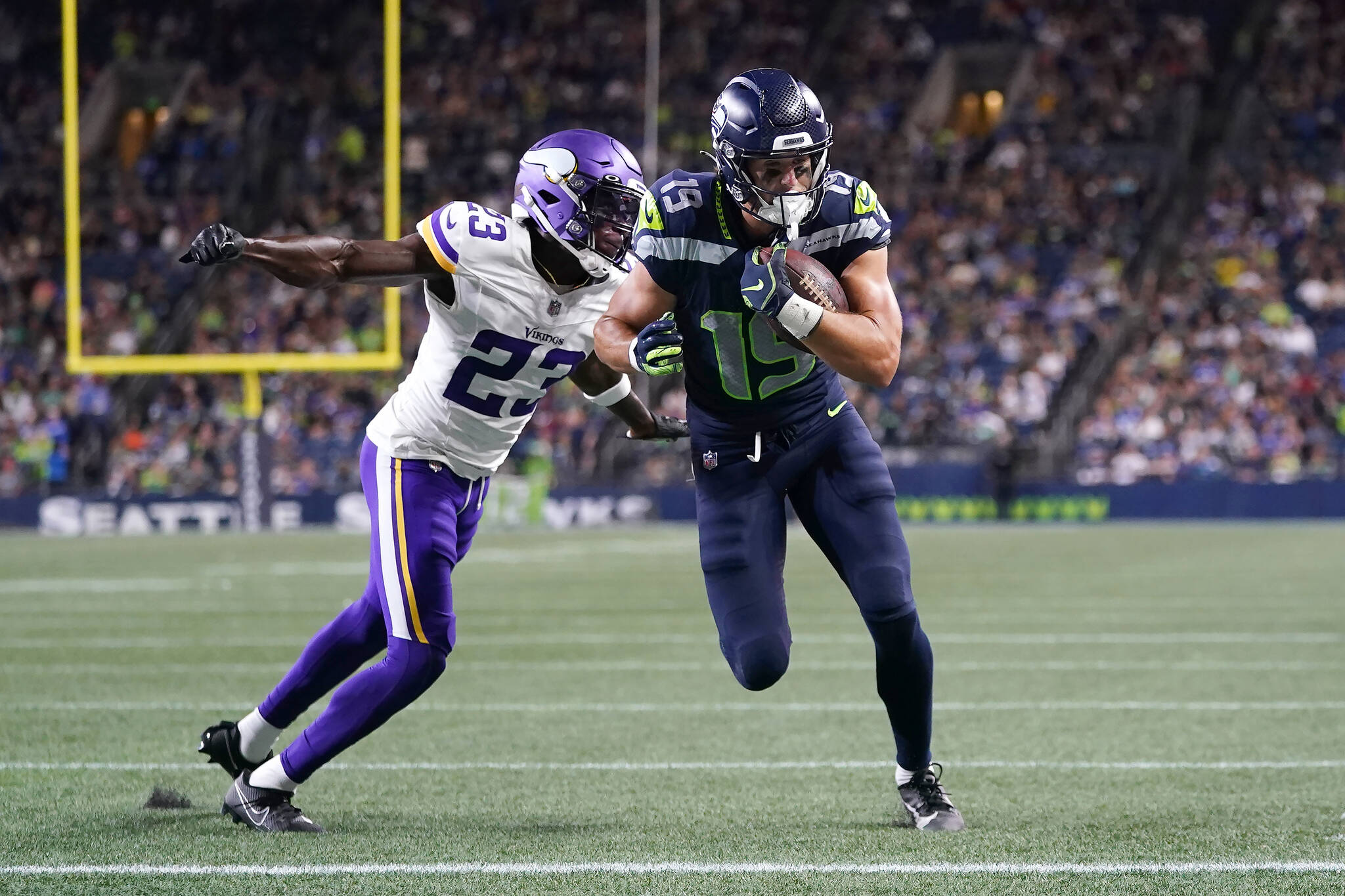 Seahawks wide receiver Jake Bobo (19) runs for a touchdown after catching a pass over Vikings cornerback Andrew Booth Jr. during the second half of a preseason game Thursday in Seattle. (AP Photo/Lindsey Wasson)