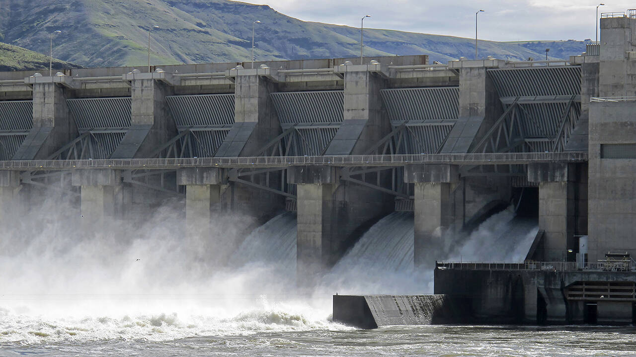 Water gushes through a spillway of the Lower Granite Dam on the Snake River near Almota, Wash., in April 2018. The Lower Granite is one of four dams on Washington’s lower Snake River above its confluence with the Columbia River. (Nicholas K. Geranios / Associated Press file photo)