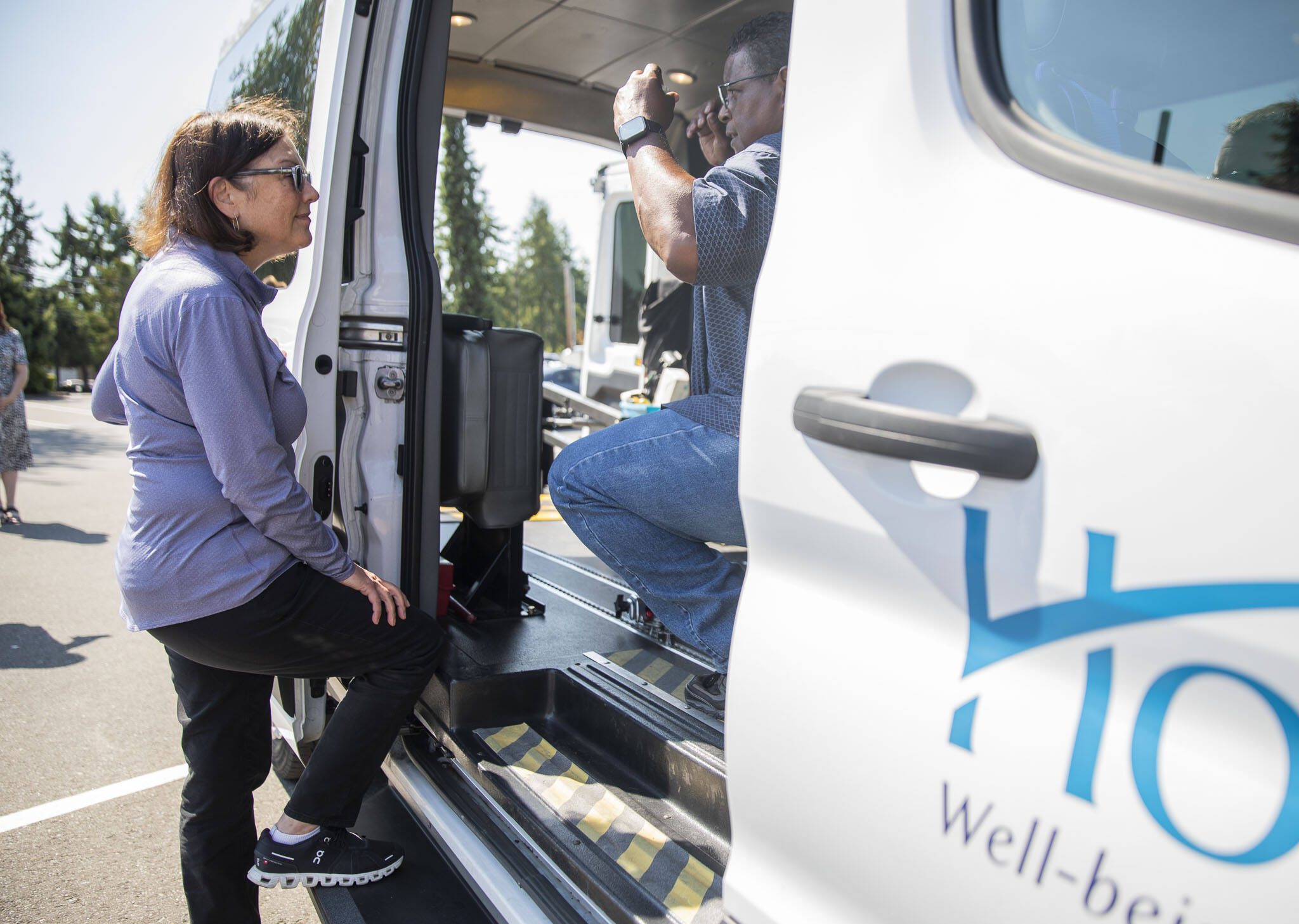 U.S. Congresswoman Suzan DelBene, left, speaks with Homage Safety, Training, and Vehicle Service Supervisor Lloyd White about their current transit vehicle on Monday, Aug. 14, 2023 in Lynnwood, Washington. (Olivia Vanni / The Herald)