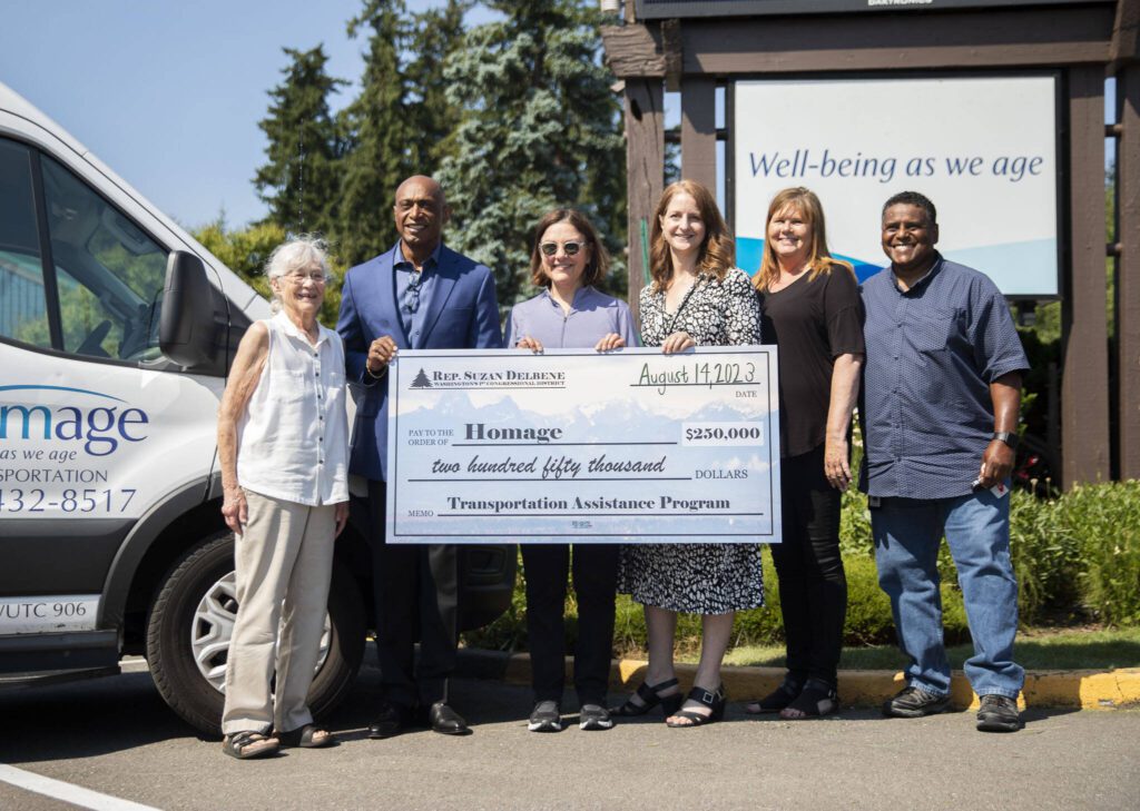 U.S. Congresswoman Suzan DelBene presenting Homage with a $250,000 ceremonial check to improve transportation for seniors across Snohomish County on Monday, Aug. 14, 2023 in Lynnwood, Washington. (Olivia Vanni / The Herald)

