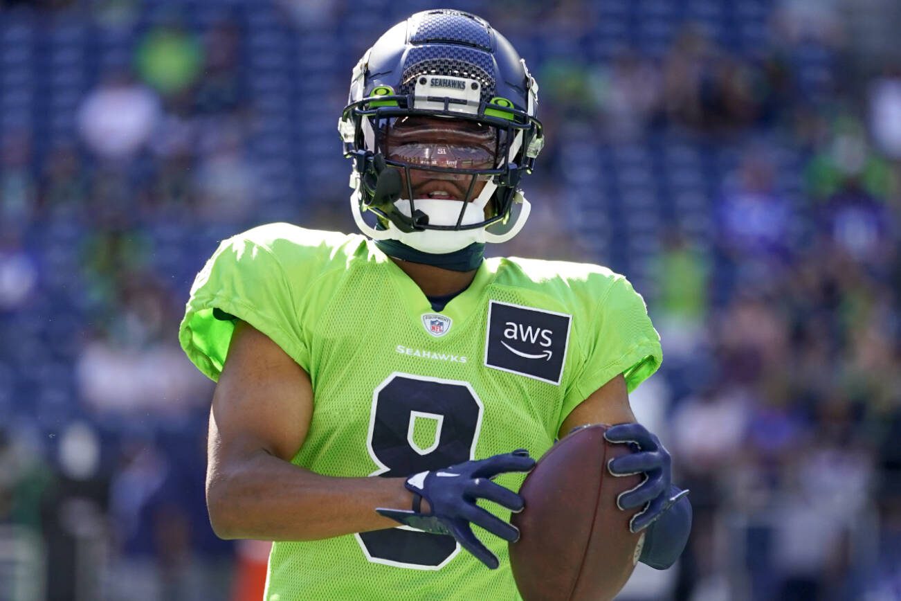 Seattle Seahawks cornerback Coby Bryant holds a football during warmups before the NFL football team's mock game, Friday, Aug. 4, 2023, in Seattle. (AP Photo/Lindsey Wasson)