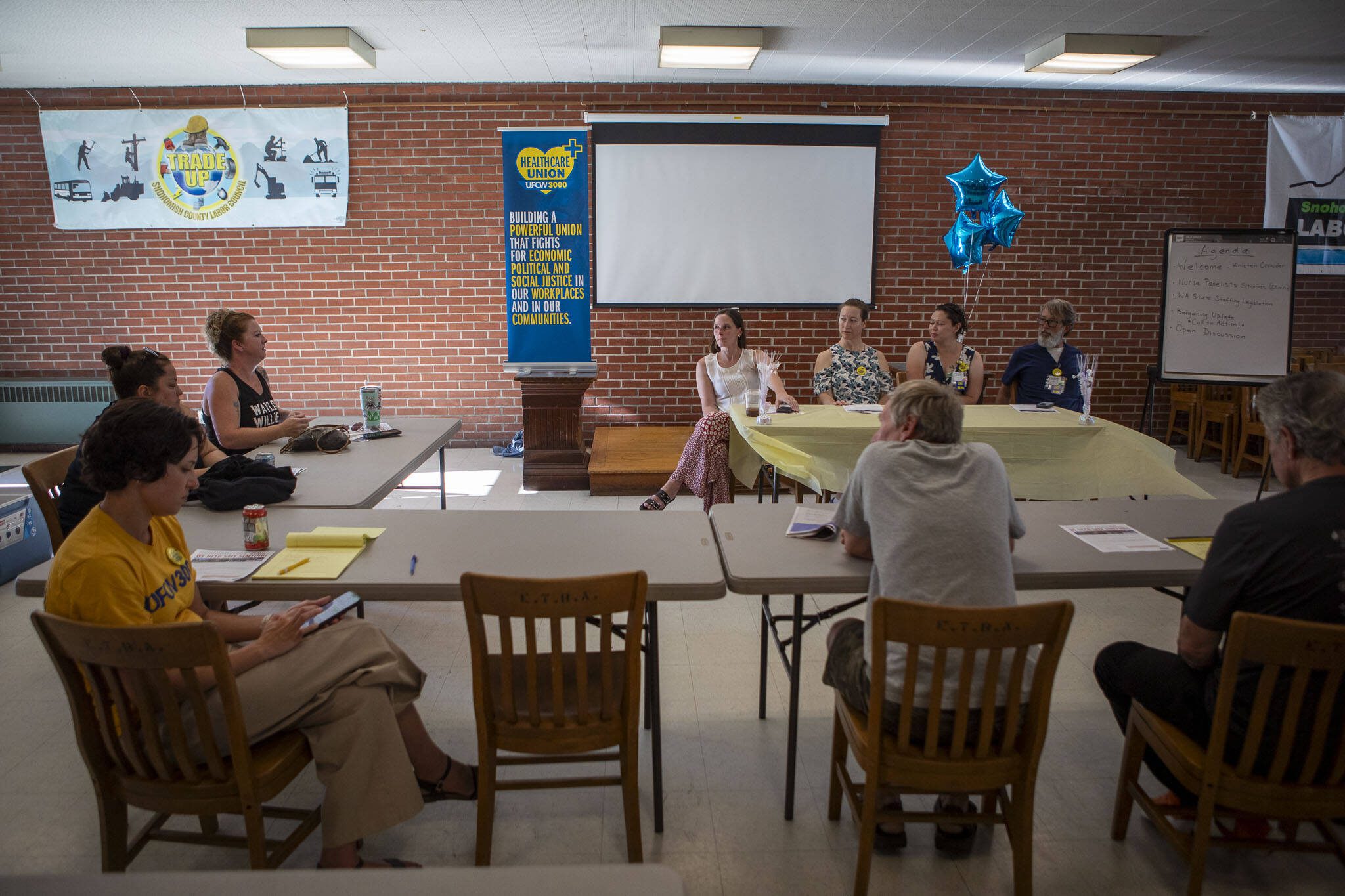 Left to right, Kelli Johnson, Mare Mullins, Kristen Crowder and George Frenz, sit on a panel during a Town Hall with UFCW 3000 Nurses at Providence Regional Medical Center at the Everett Labor Temple in Everett, Washington on Wednesday, Aug. 16, 2023. (Annie Barker / The Herald)