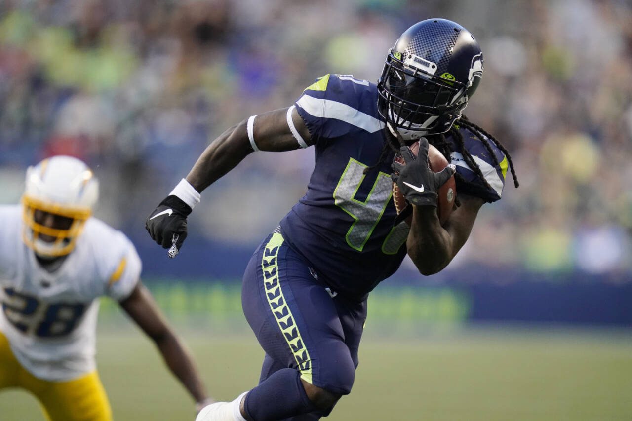 Alex Collins carries the ball while playing for the Seattle Seahawks against the Los Angeles Chargers during a game Aug. 28, 2021, in Seattle. (AP Photo/Elaine Thompson)
