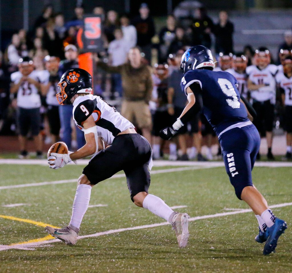 Granite Falls’ Johnathan Roberts picks off a ball tipped into the air and begins to take it the other way against Sultan on Sept. 30, 2022, at Sultan High School. (Ryan Berry / The Herald)
