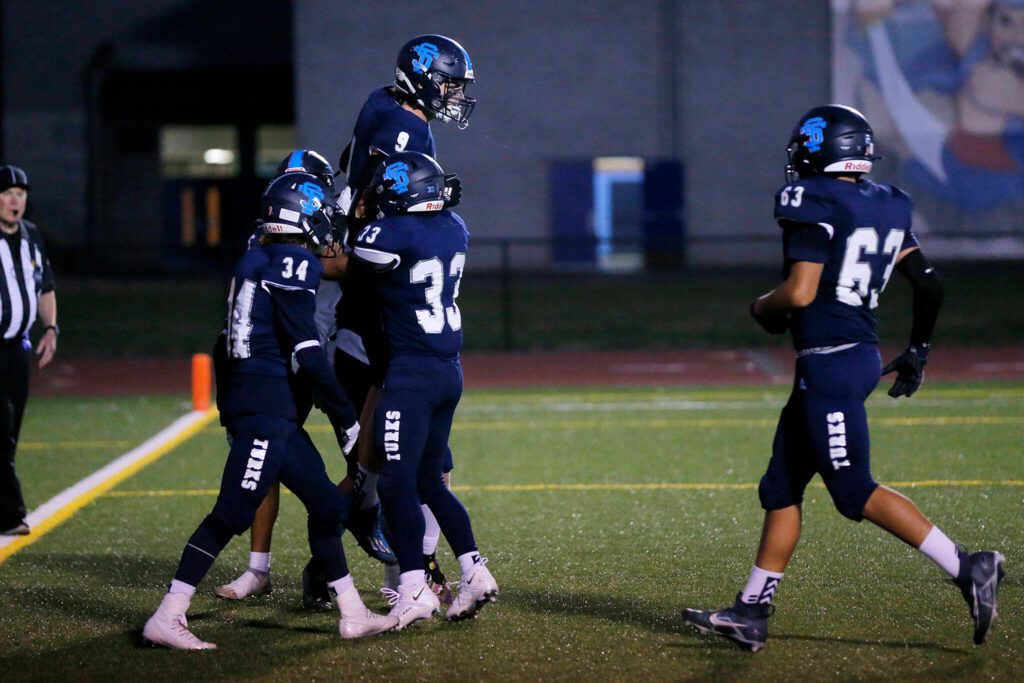 Sultan’s Hayden Murphy gets lifted in the air by teammates after scoring a touchdown against Granite Falls on Sept. 30, 2022, at Sultan High School. (Ryan Berry / The Herald)
