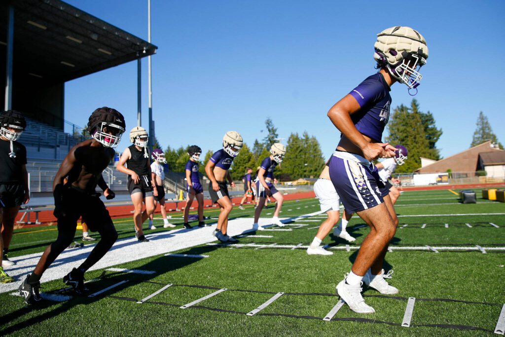 Lake Stevens players run through conditioning drills during the Vikings’ first practice of the year Wednesday, August 16, 2023, in Lake Stevens, Washington. (Ryan Berry / The Herald)
