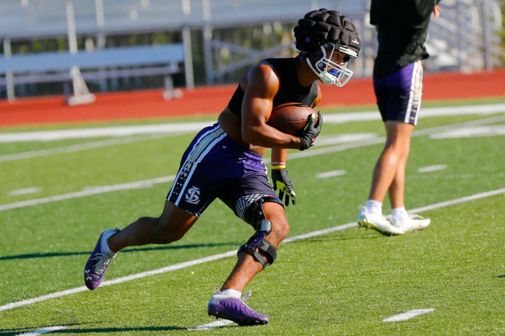 Lake Stevens junior running back Jayshon Limar takes a shovel pass during the Vikings’ first practice of the year Wednesday, August 16, 2023, in Lake Stevens, Washington. (Ryan Berry / The Herald)
