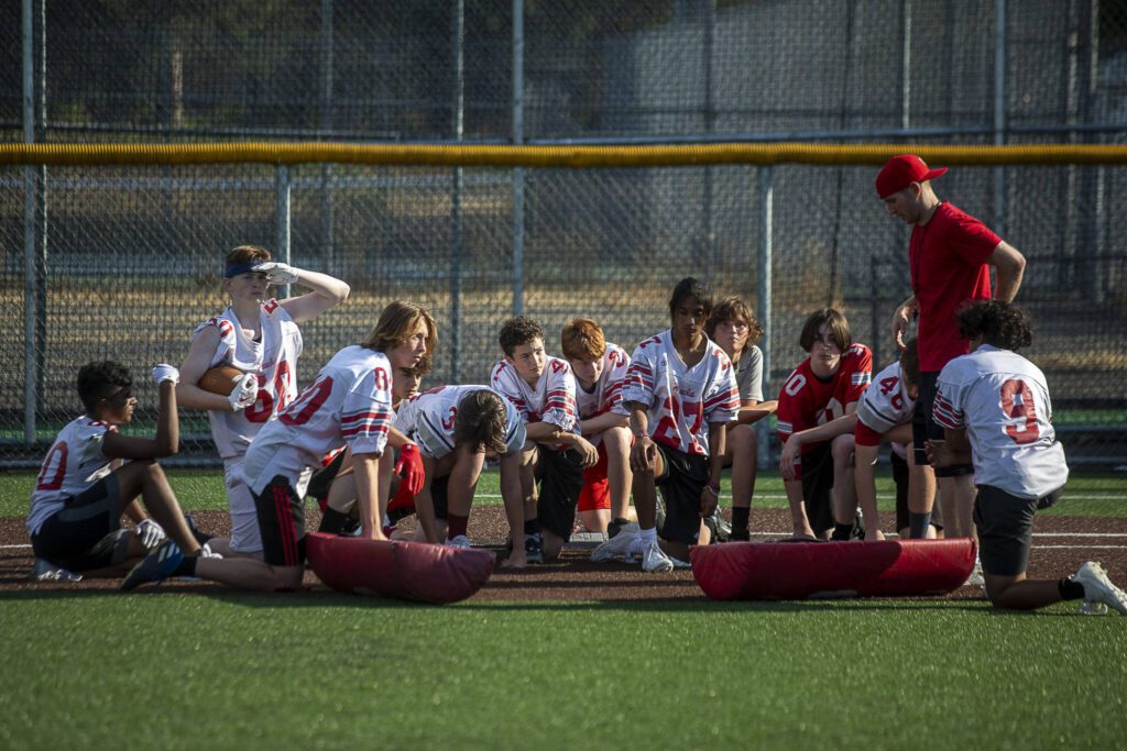 Players listen during a huddle during a football practice Thursday at Mountlake Terrace High School. (Annie Barker / The Herald)
