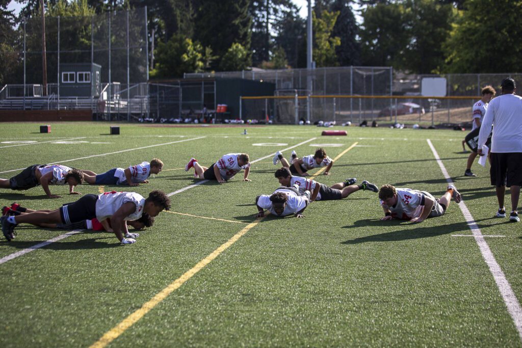 Players do push-ups during a football practice Thursday at Mountlake Terrace High School. (Annie Barker / The Herald)
