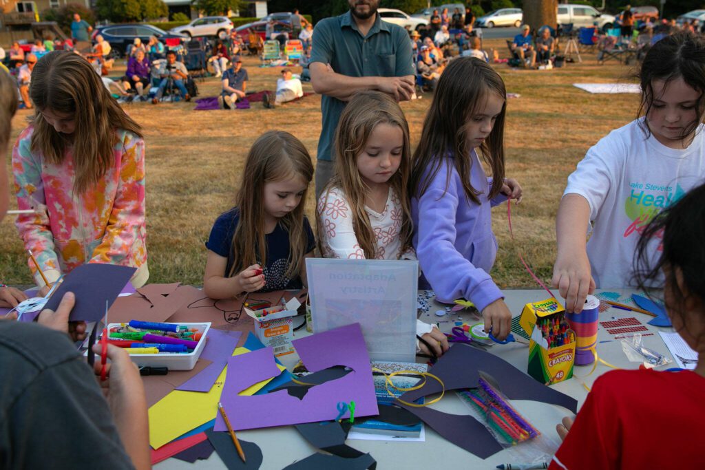 Children work on arts and crafts during the Pilchuck Audubon Society’s Swift Night Out on Saturday, August 19, 2023, at Frank Wagner Elementary School in Monroe, Washington. (Ryan Berry / The Herald)
