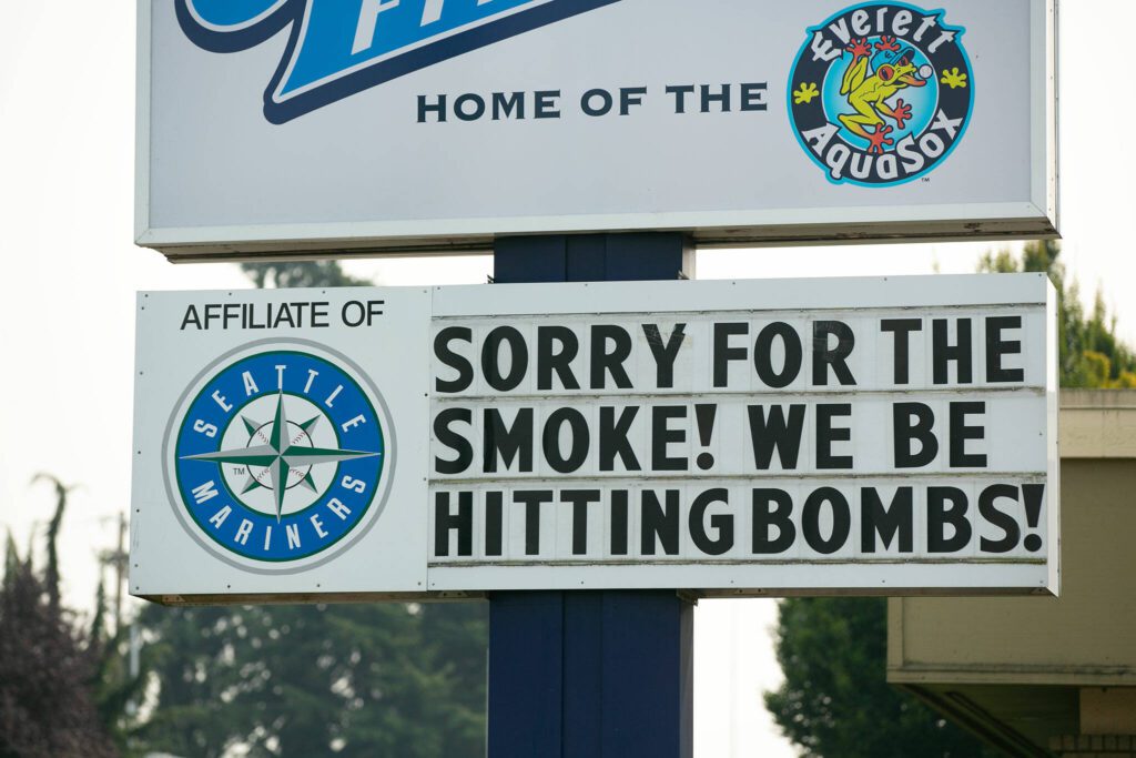Funko Field’s sign along Broadway makes light of smokey conditions on Sunday, August 20, 2023, in Everett, Washington. (Ryan Berry / The Herald)
