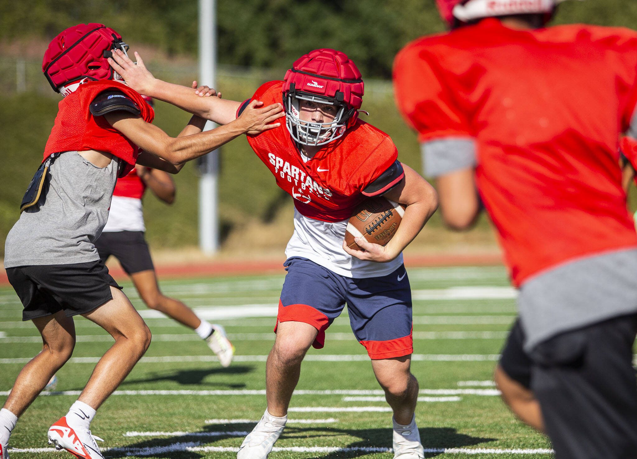 Stanwood’s Silas Turpin runs the ball during drills at practice Friday in Stanwood. (Olivia Vanni / The Herald)