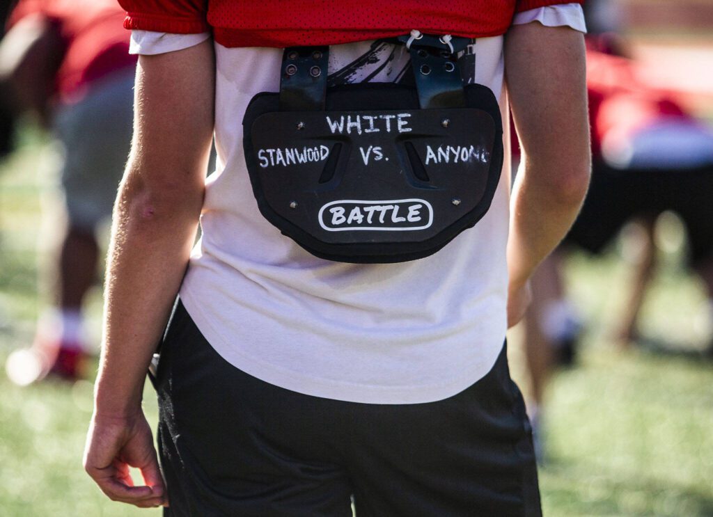 A Stanwood player wears padding with “Stanwood vs. Anyone” written on the back during practice on Friday, Aug. 18, 2023 in Stanwood, Washington. (Olivia Vanni / The Herald)
