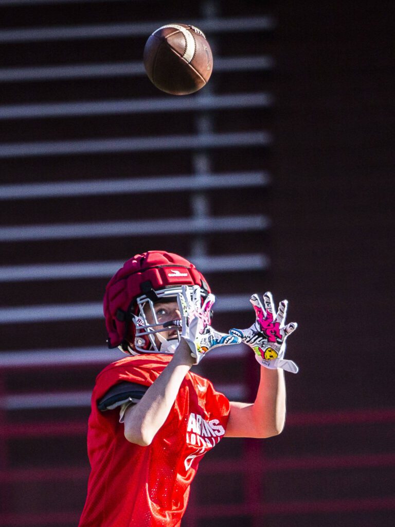 A Stanwood player reaches out to make a catch during practice on Friday, Aug. 18, 2023 in Stanwood, Washington. (Olivia Vanni / The Herald)
