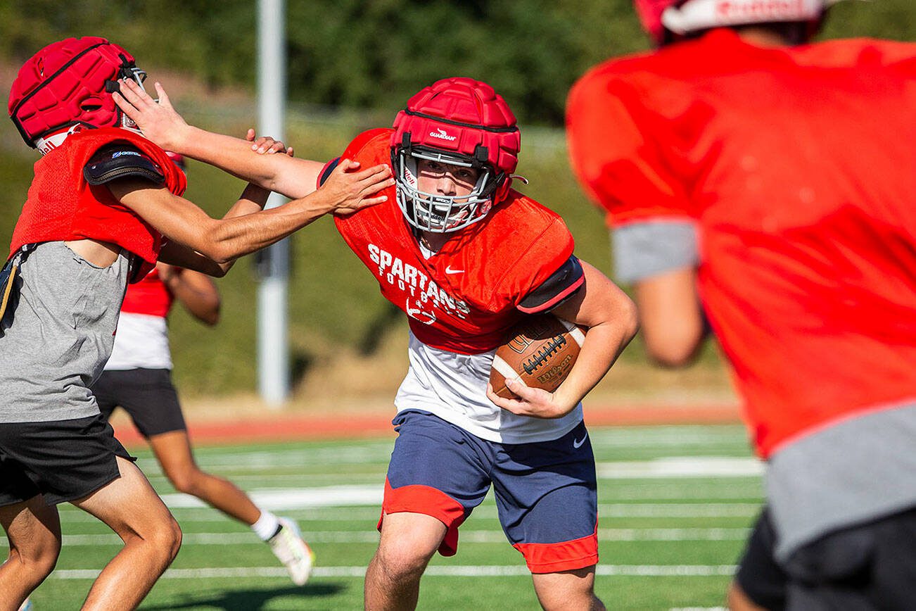 Stanwood's Silas Turpin runs the ball during drills at practice on Friday, Aug. 18, 2023 in Stanwood, Washington. (Olivia Vanni / The Herald)