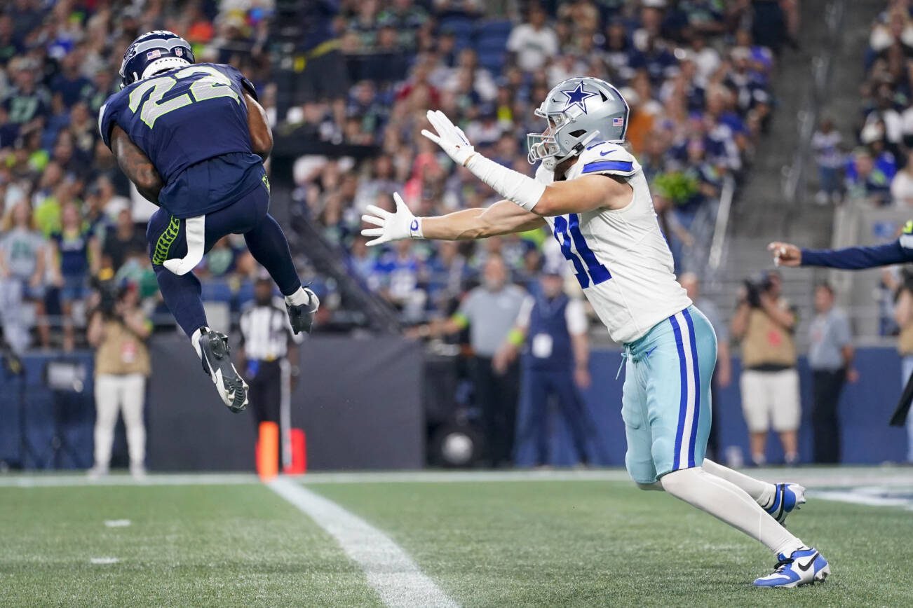 Seattle Seahawks cornerback Tre Brown intercepts a pass intended for Dallas Cowboys wide receiver Simi Fehoko during the second half of a preseason NFL football game Saturday, Aug. 19, 2023, in Seattle. (AP Photo/Lindsey Wasson)