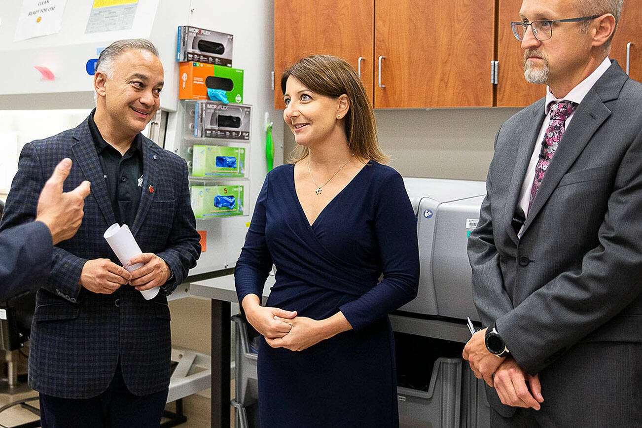 Washington state Secretary of Health Dr. Umair A. Shah (left to right), Centers for Disease Control and Prevention Director Mandy Cohen and Microbiology Office Director Dr. Brian Hiatt tour a handful of labs in the Public Health Laboratories building on Friday, Aug. 25, 2023 in Shoreline, Washington. (Olivia Vanni / The Herald)