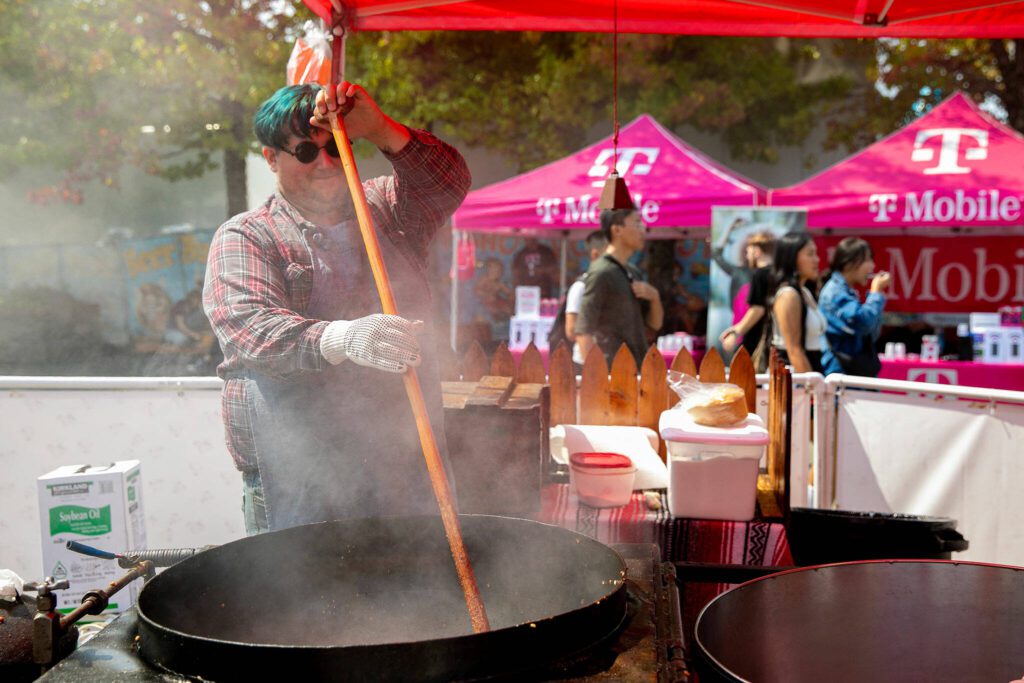 Mike McNiven of Pioneer Popcorn stirs a batch of kettle corn during opening day of the Evergreen State Fair on Thursday, August 24, 2023, in Monroe, Washington. (Ryan Berry / The Herald)
