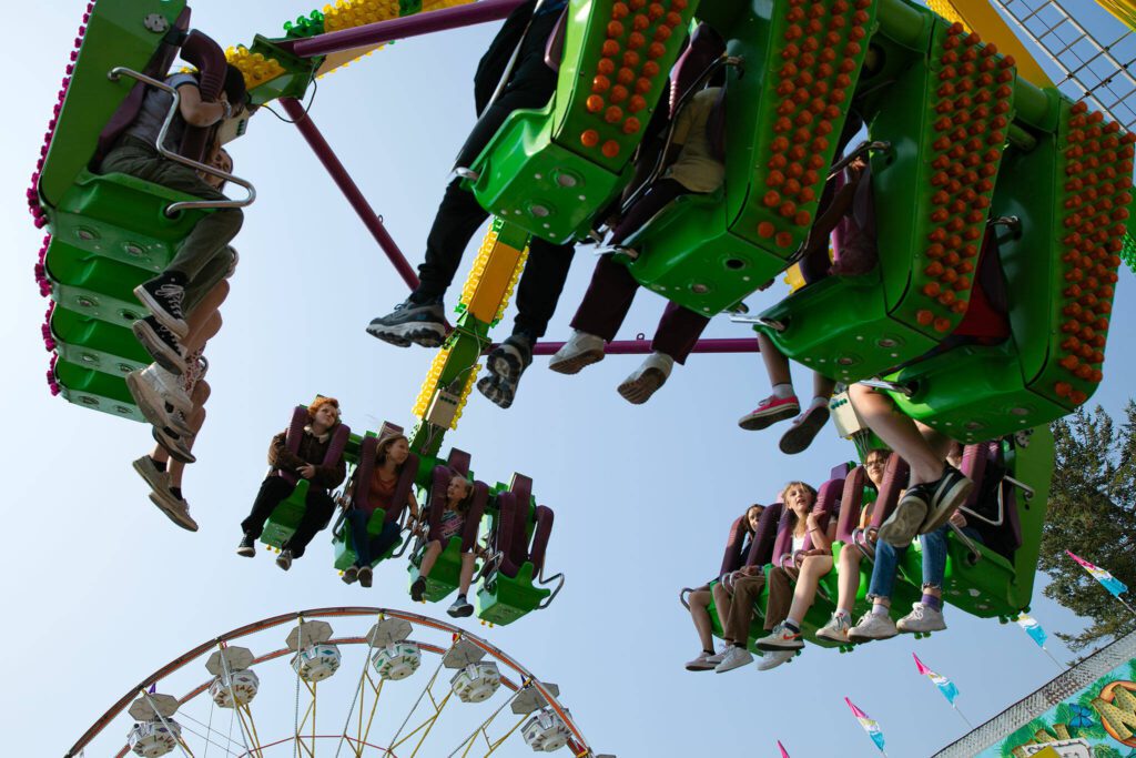 Thrill seekers fly through the air on a ride during opening day of the Evergreen State Fair on Thursday, August 24, 2023, in Monroe, Washington. (Ryan Berry / The Herald)
