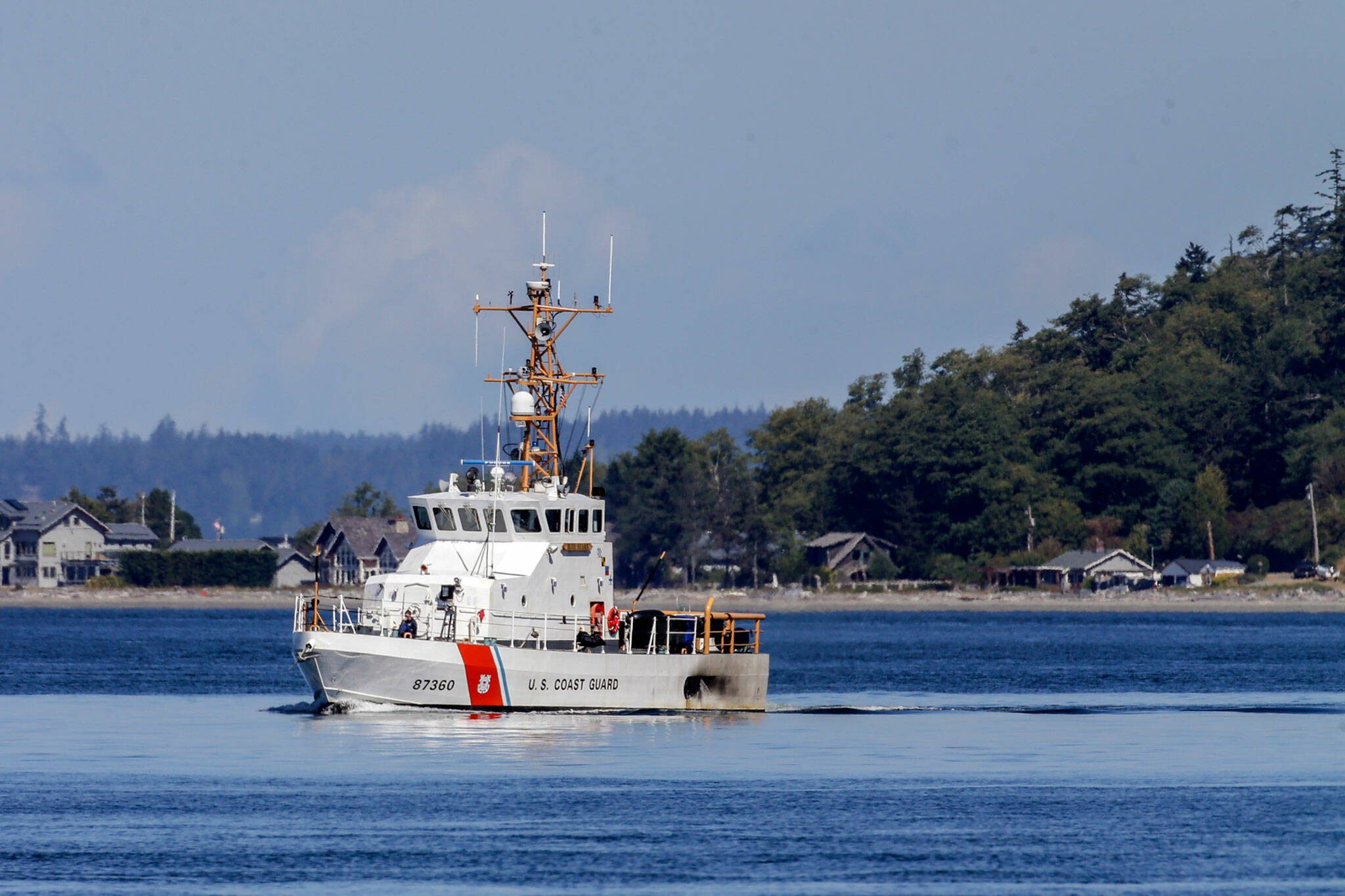 A Coast Guard cutter searches for a crashed chartered floatplane near Mutiny Bay Monday afternoon in Freeland, Washington on August 5, 2022. (Kevin Clark / The Herald)