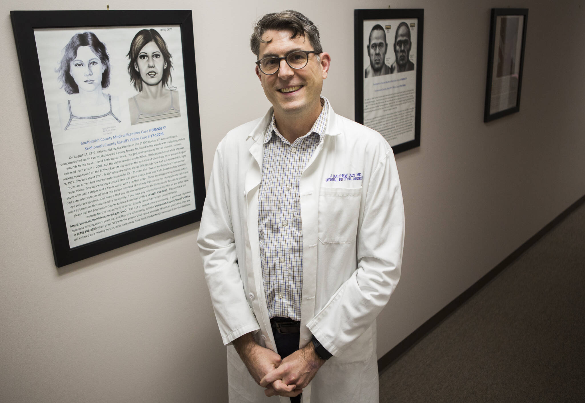 Dr. J. Matthew Lacy along a wall of cold cases at the Snohomish County Medical Examiner’s Office on Dec. 4, 2019 in Everett, Washington. (Olivia Vanni / The Herald)