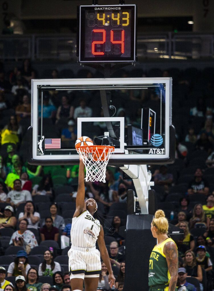 Chicago Sky’s Elizabeth Williams jumps up to try and dislodge the basketball after it become stuck between the rim and the backboard during the game against the Seattle Storm at Climate Pledge Arena on Sunday, Aug. 27, 2023 in Seattle, Washington. (Olivia Vanni / The Herald)