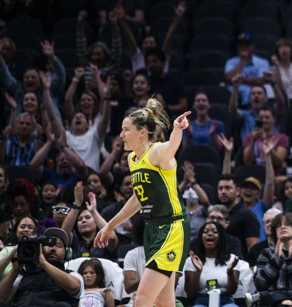 The crowd cheers and Seattle Storm’s Sami Whitcomb points to Seattle Storm’s Jewell Loyd after she makes a three-point shot during the game against the Chicago Sky at Climate Pledge Arena on Sunday, Aug. 27, 2023 in Seattle, Washington. (Olivia Vanni / The Herald)
