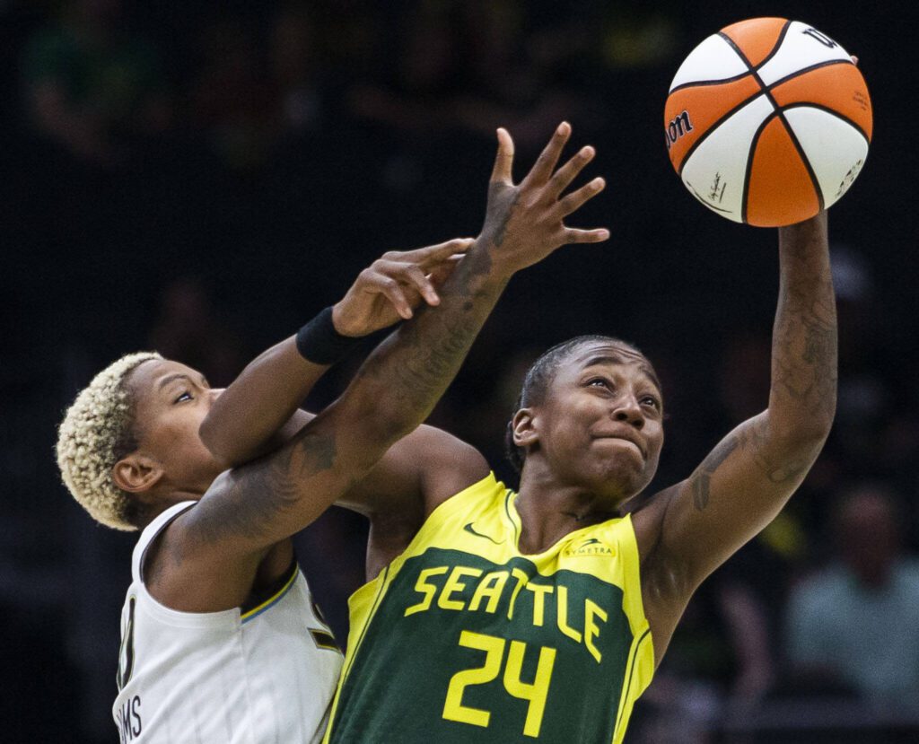 Seattle Storm’s Jewell Loyd reaches out for the ball /while being guarded by Chicago Sky’s Courtney Williams during the game at Climate Pledge Arena on Sunday, Aug. 27, 2023 in Seattle, Washington. (Olivia Vanni / The Herald)