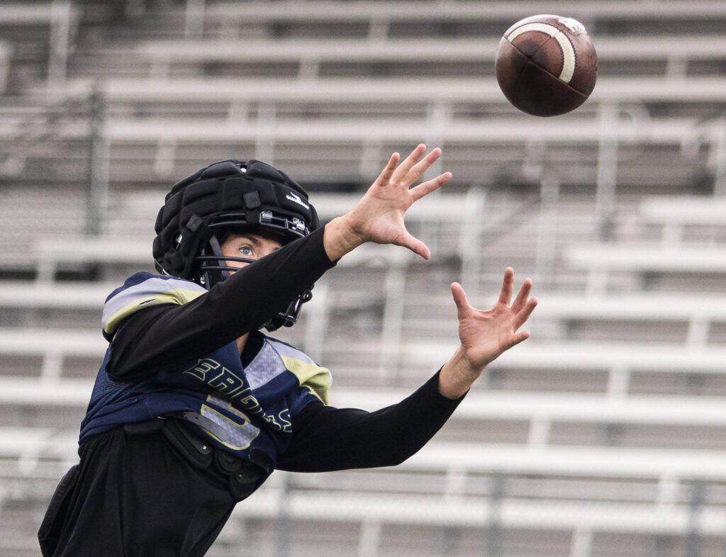 Jacoby Falor makes a catch during practice on Wednesday at Arlington High School. (Olivia Vanni / The Herald)
