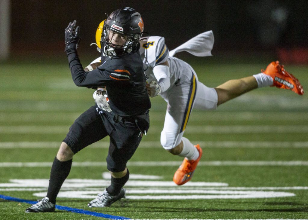 Monroe’s Mason Davis is tackled while running the ball during a game against Ferndale on Oct. 28, 2022, in Monroe, Washington. (Olivia Vanni / The Herald)
