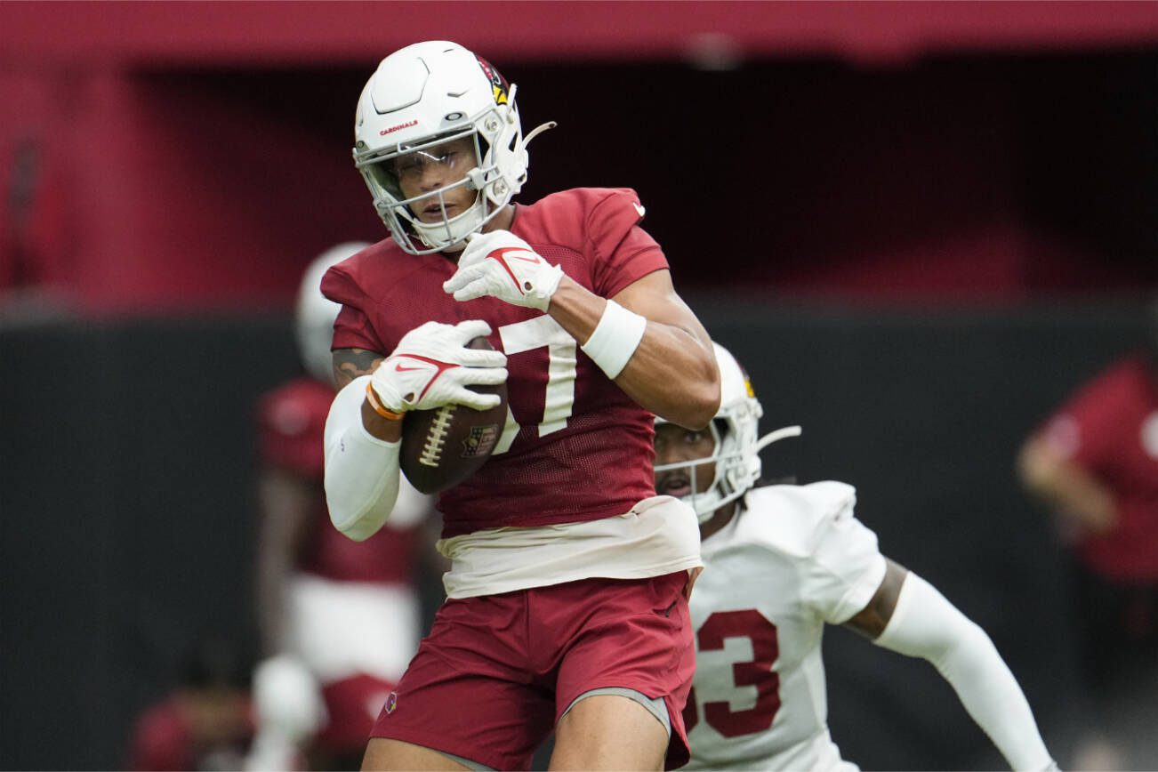 Arizona Cardinals wide receiver Daniel Arias, left, makes a catch in front of Cardinals cornerback Antonio Hamilton during NFL football training camp practice at State Farm Stadium Saturday, July 29, 2023, in Glendale, Ariz. (AP Photo/Ross D. Franklin)