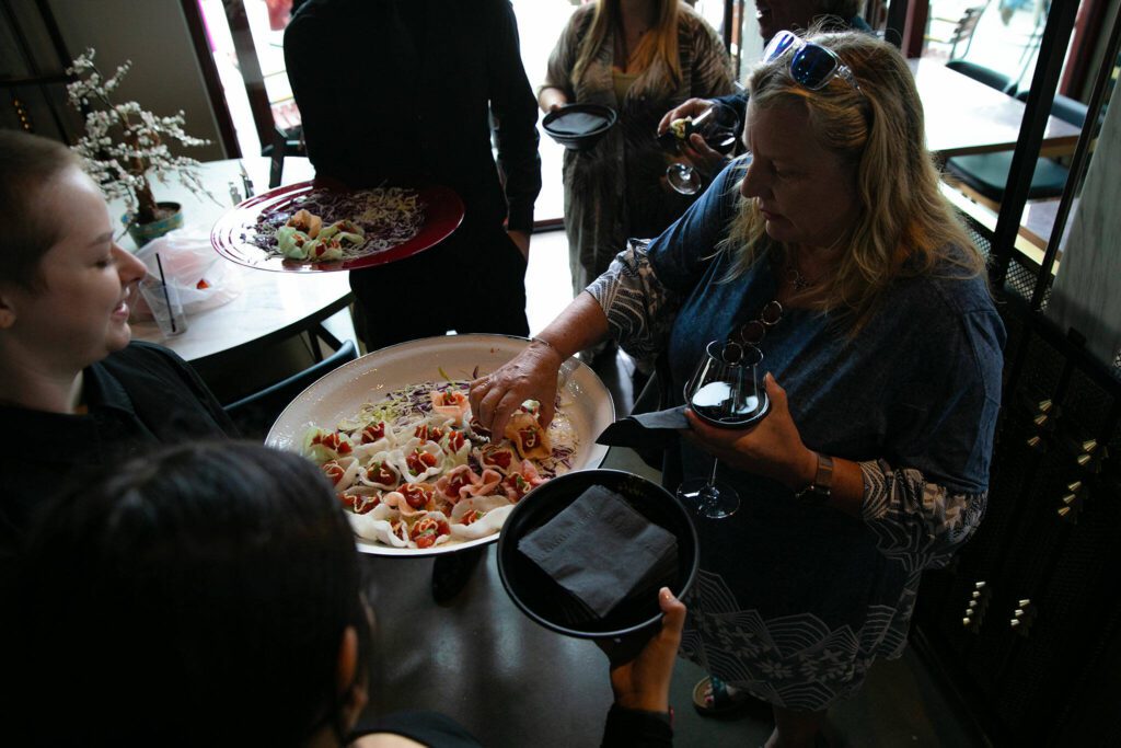 Ahi tuna hors d’oeurves are brought around to guests during the opening of Fisherman Jack’s at the Port of Everett on Wednesday, August 30, 2023, in Everett, Washington. (Ryan Berry / The Herald)
