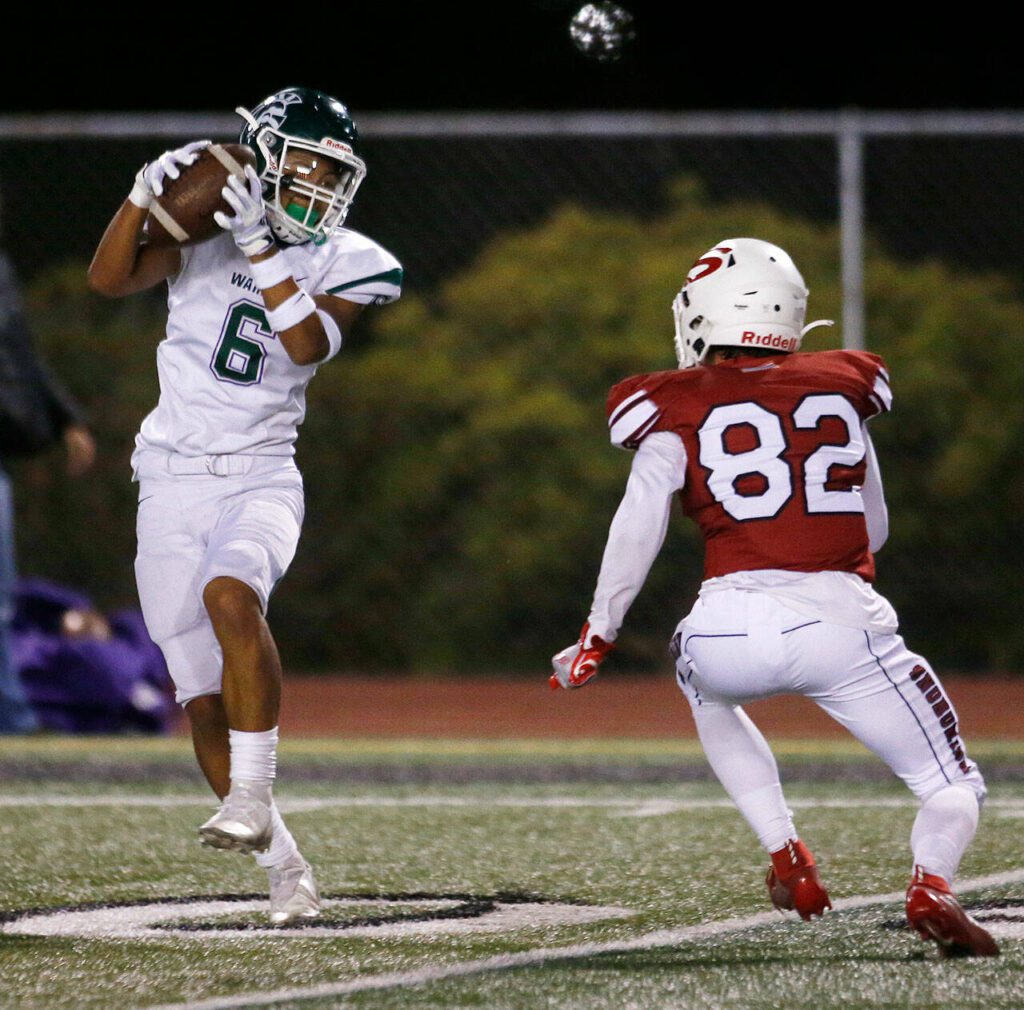 Edmonds-Woodway’s Jesse Hart comes down with a long reception during a game against Snohomish on Sept. 23, 2022, at Veterans Memorial Stadium in Snohomish. (Ryan Berry / The Herald)
